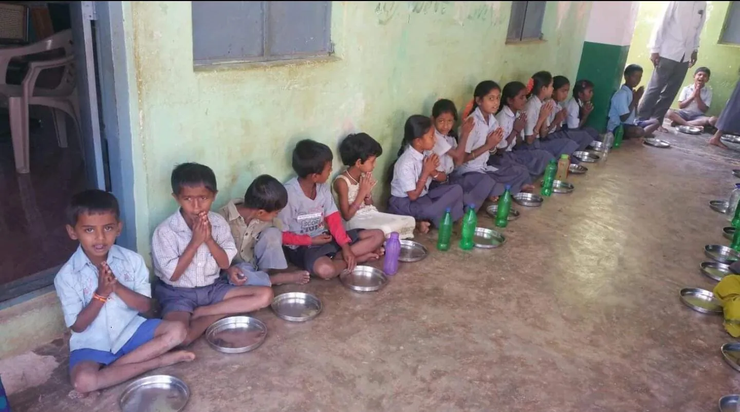 Children receiving educational supplies through Law Park Educational Trust